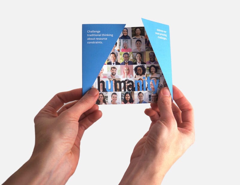 hands holding mini brochure