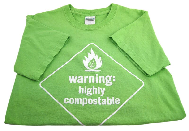 bright green t-shirt with safety symbol and text, Warning: Highly Compostable